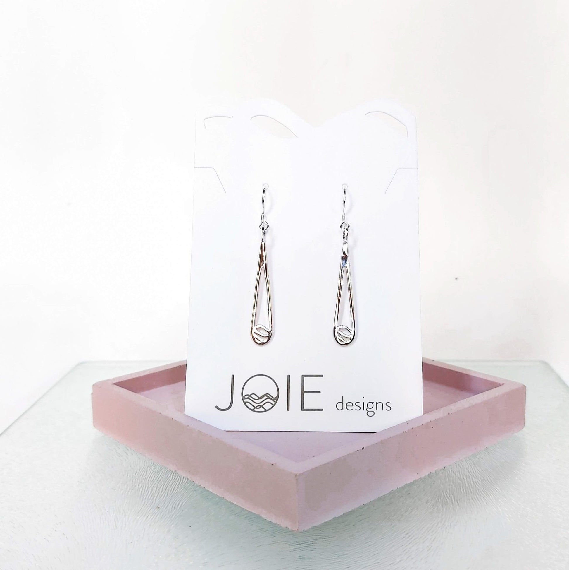 925 sterling silver Indra raindrop design earrings showcased on a jewellery card sitting on pink concrete coaster- 2