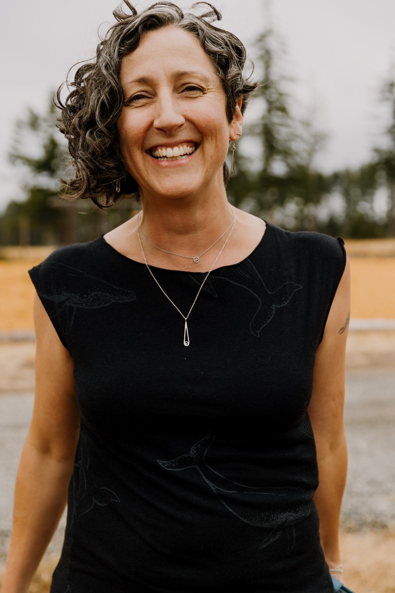 Designer Rosie wearing the Indra water drop necklace layered with a Tofino adjustable necklace and Indra Water drop earrings