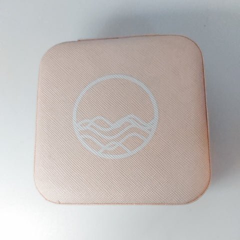 close up of logo on pink travel jewelry case
