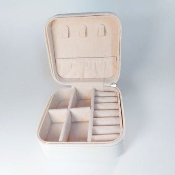 Beige jewelry case open to show compartments