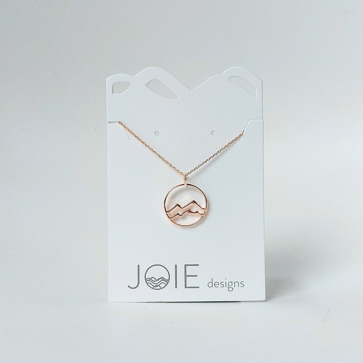 gold plated little coast mountain circle pendant necklace on white jewelry card