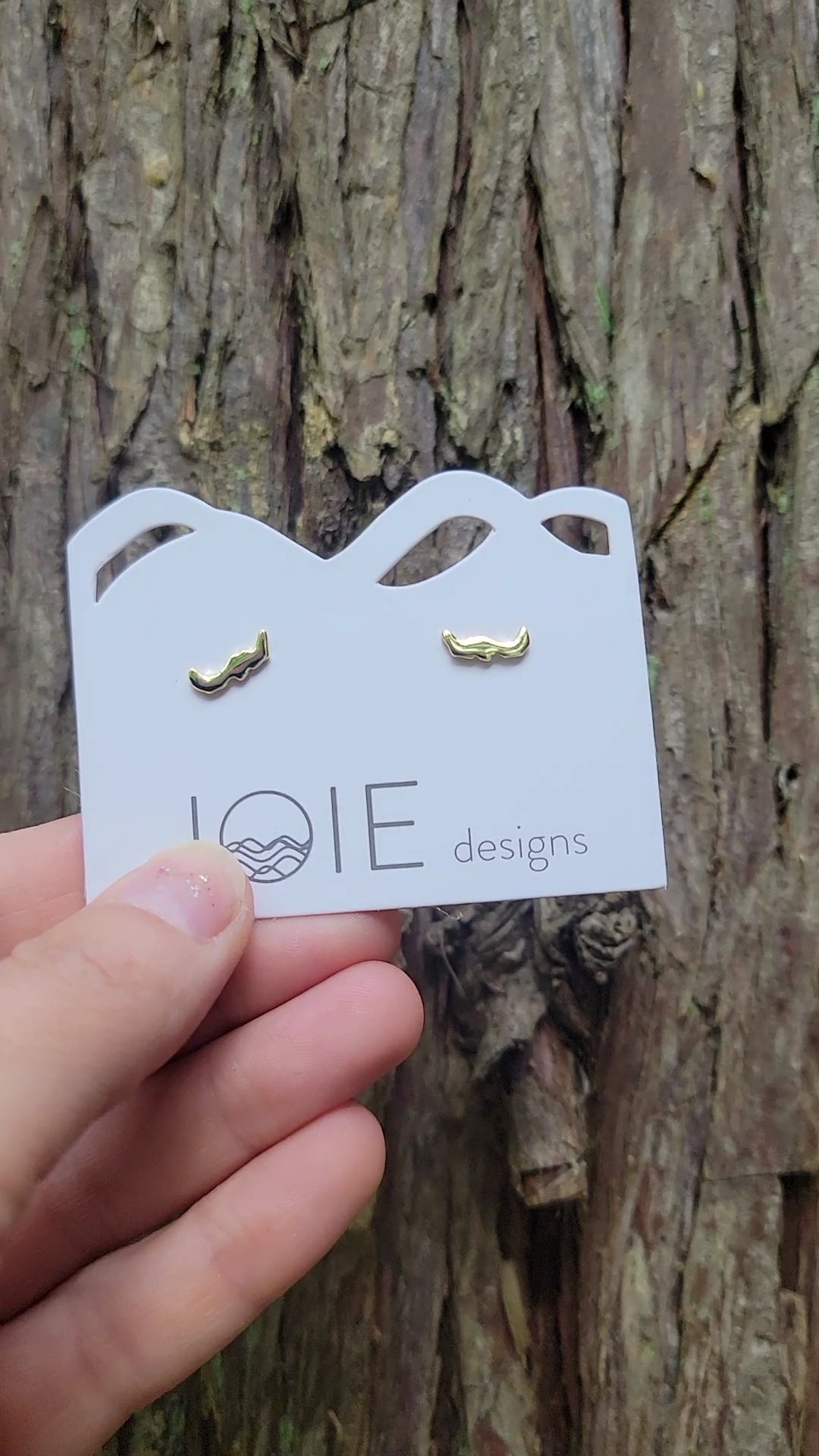 little Savary island stud earrings in gold plated sterling silver on jewelry card with tree background
