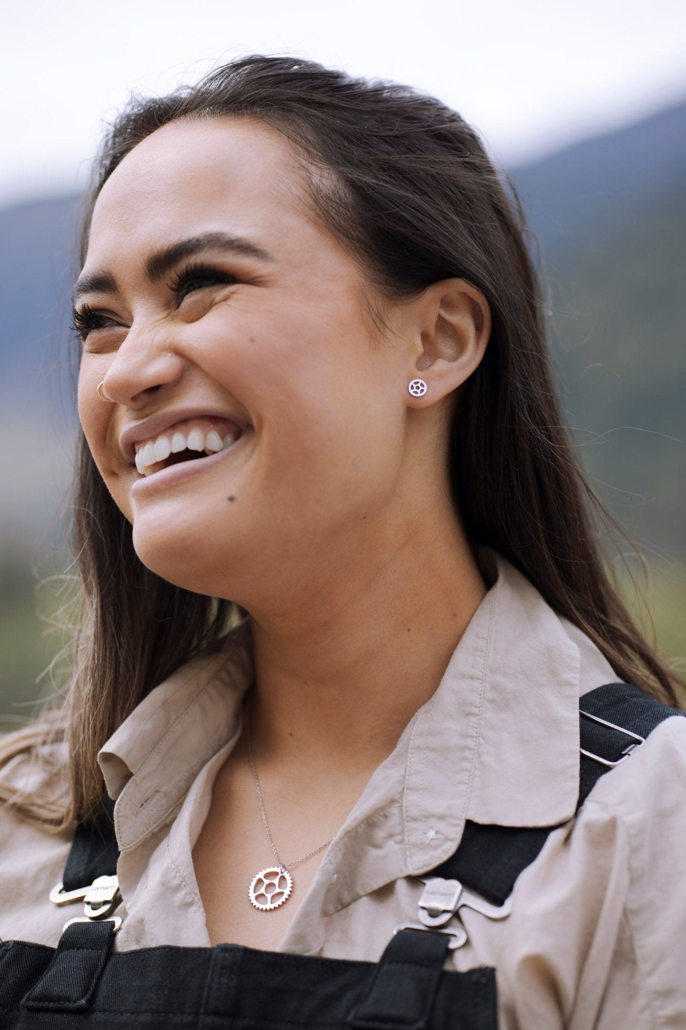 woman wearing sterling silver bike chain ring stud earrings with nature background