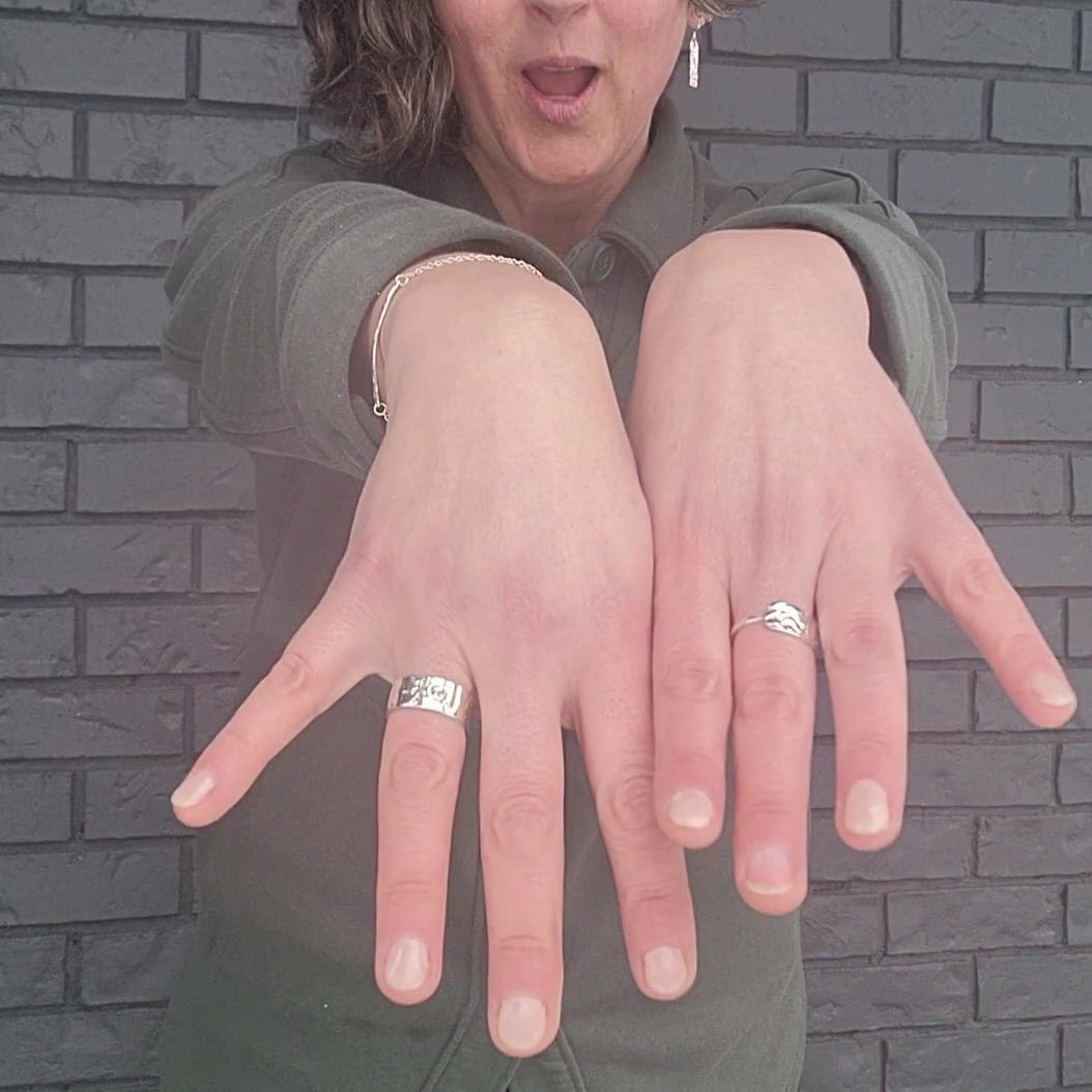 model wearing silver Nerissa and Marley rings with wood natural texture