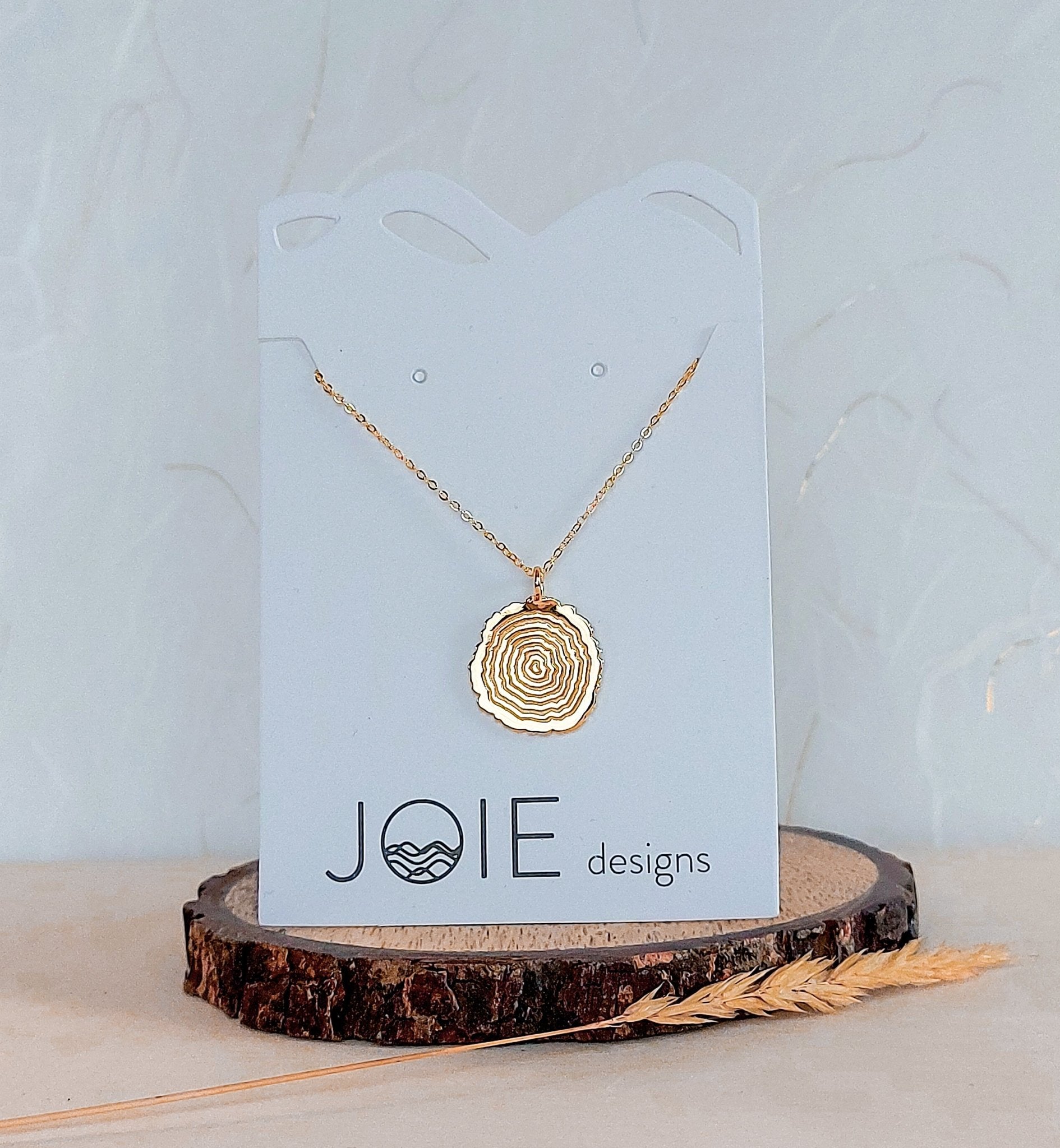 18k yellow gold plated tree rings inspired pendant necklace showcased on a jewellery card