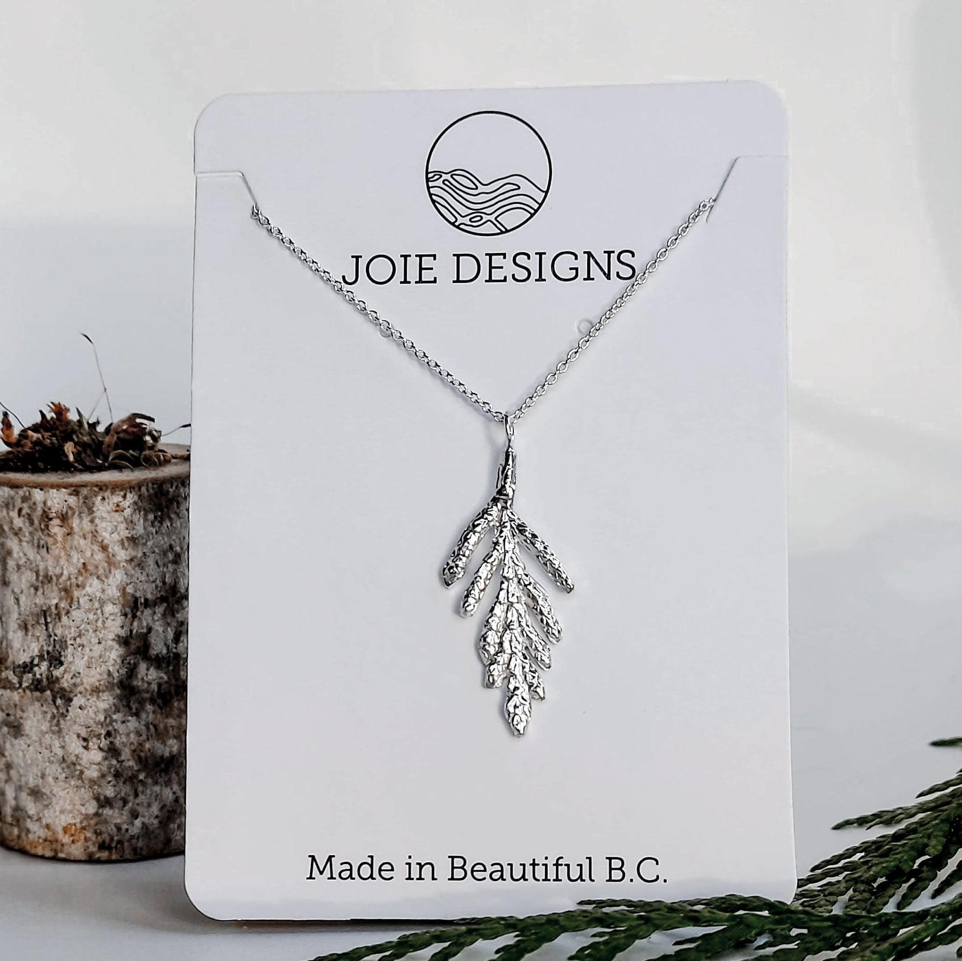 925 sterling silver cedar branch design pendant necklace on a jewelry card