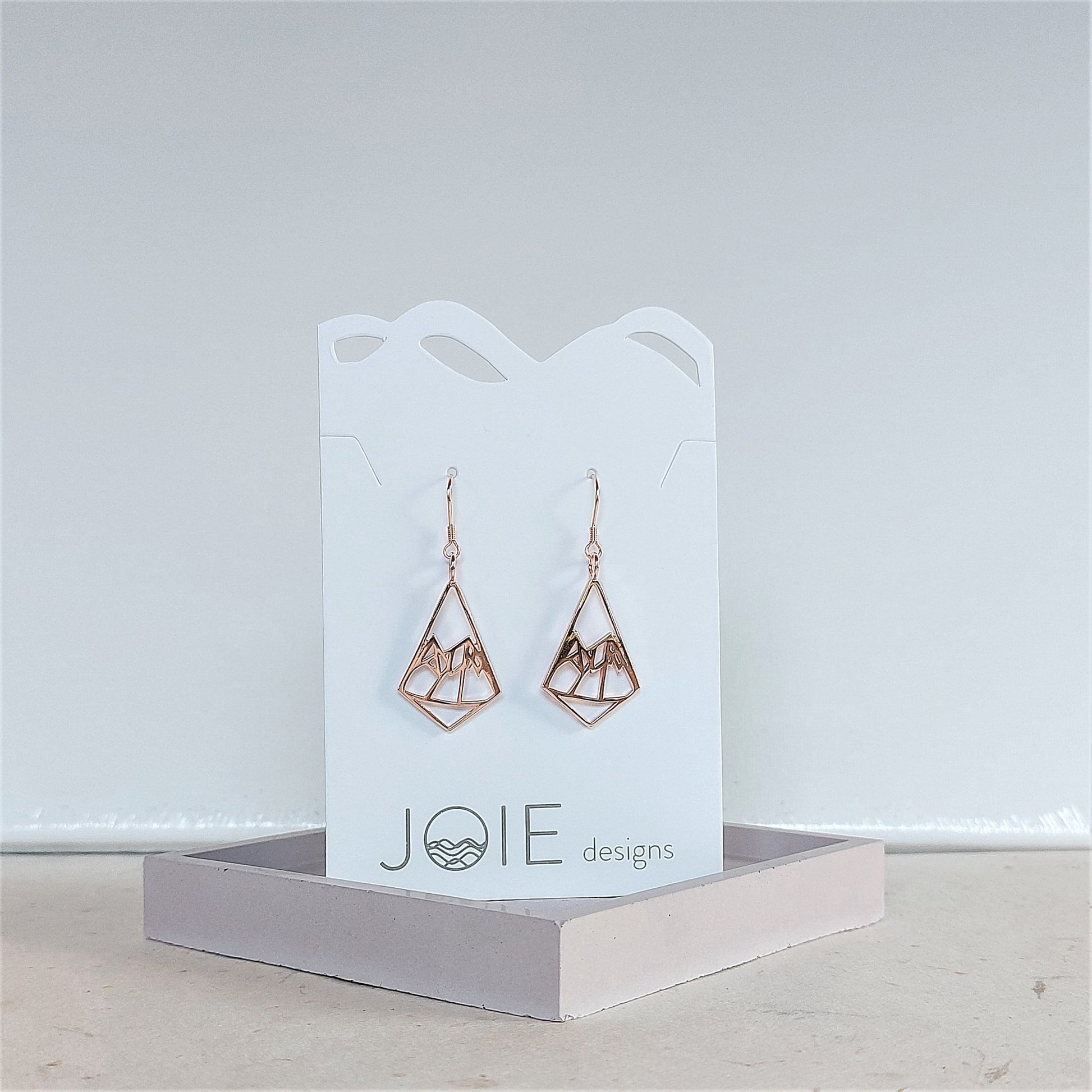 18k rose gold plated geo mountain design dangle earring on a jewelry card