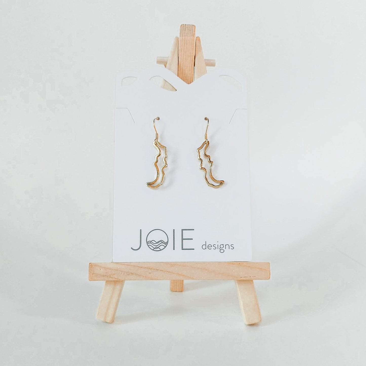 Rose Gold plated Petite Simply Savary drop earrings on white jewelry card on small wood easel