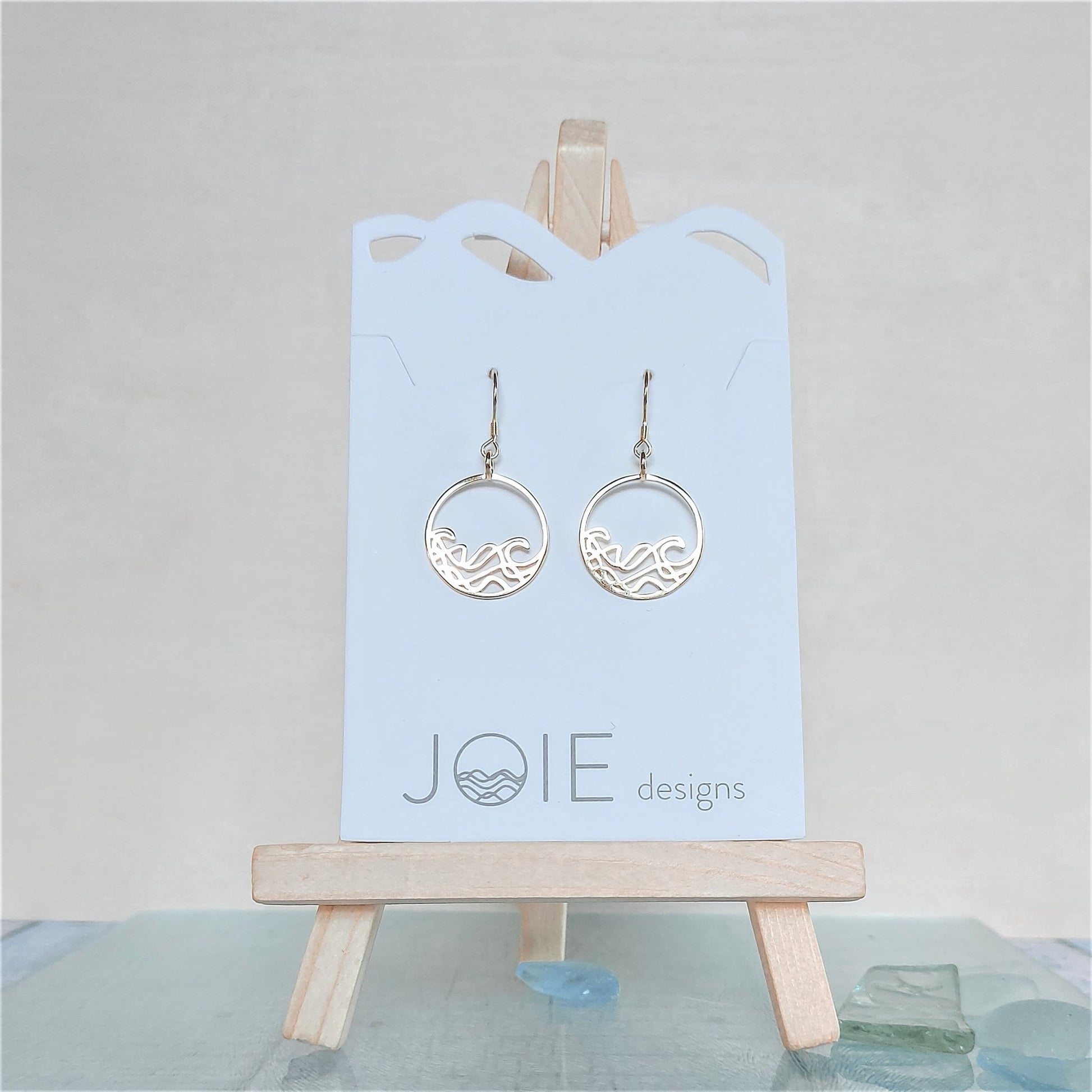 18k plated yellow gold 925 sterling silver Petite Sombrio circle surf earrings on a white jewelry card