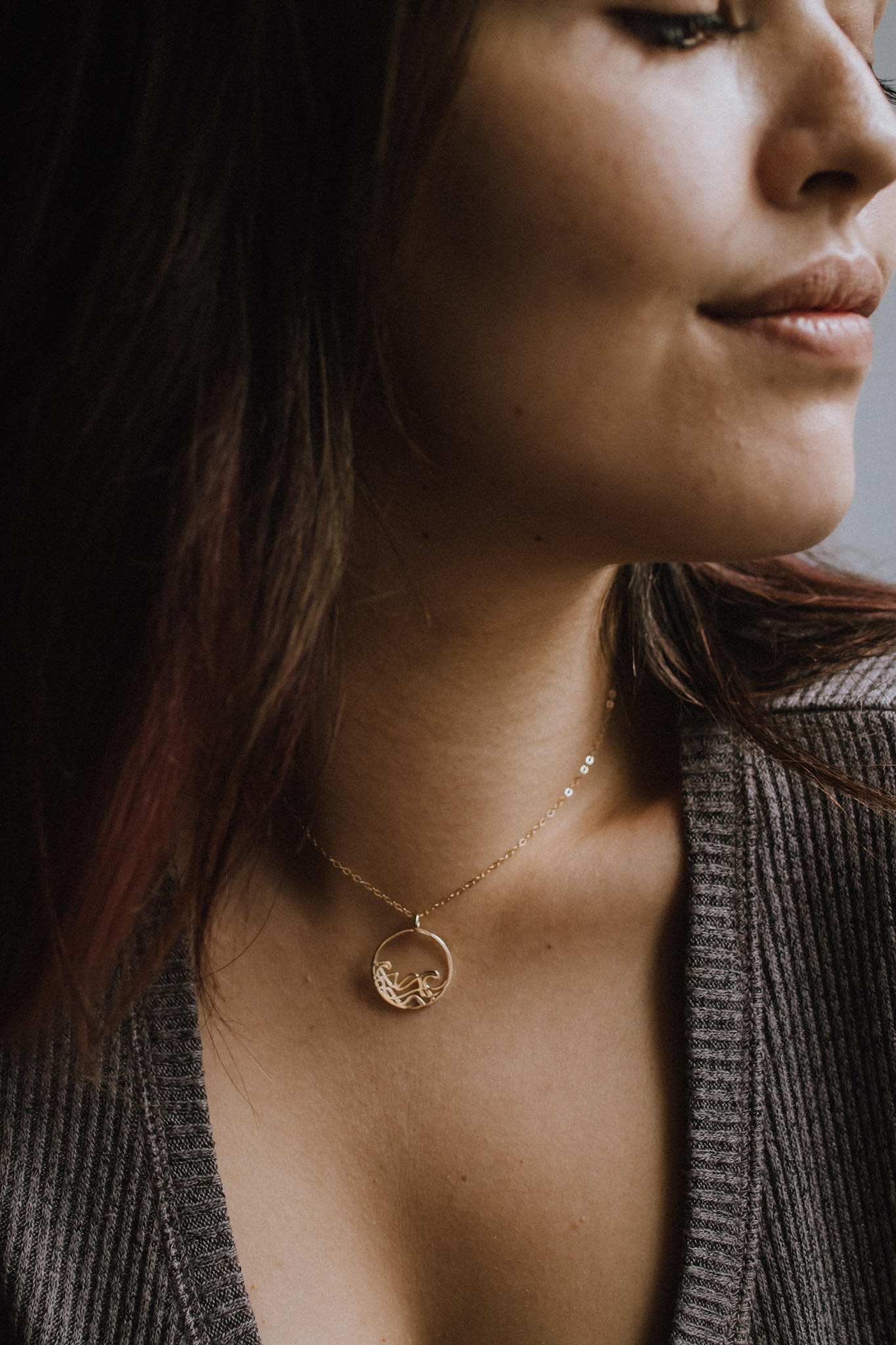 Model wearing 18k gold plated Petite Sombrio Ocean Surf Wave Circle Necklace