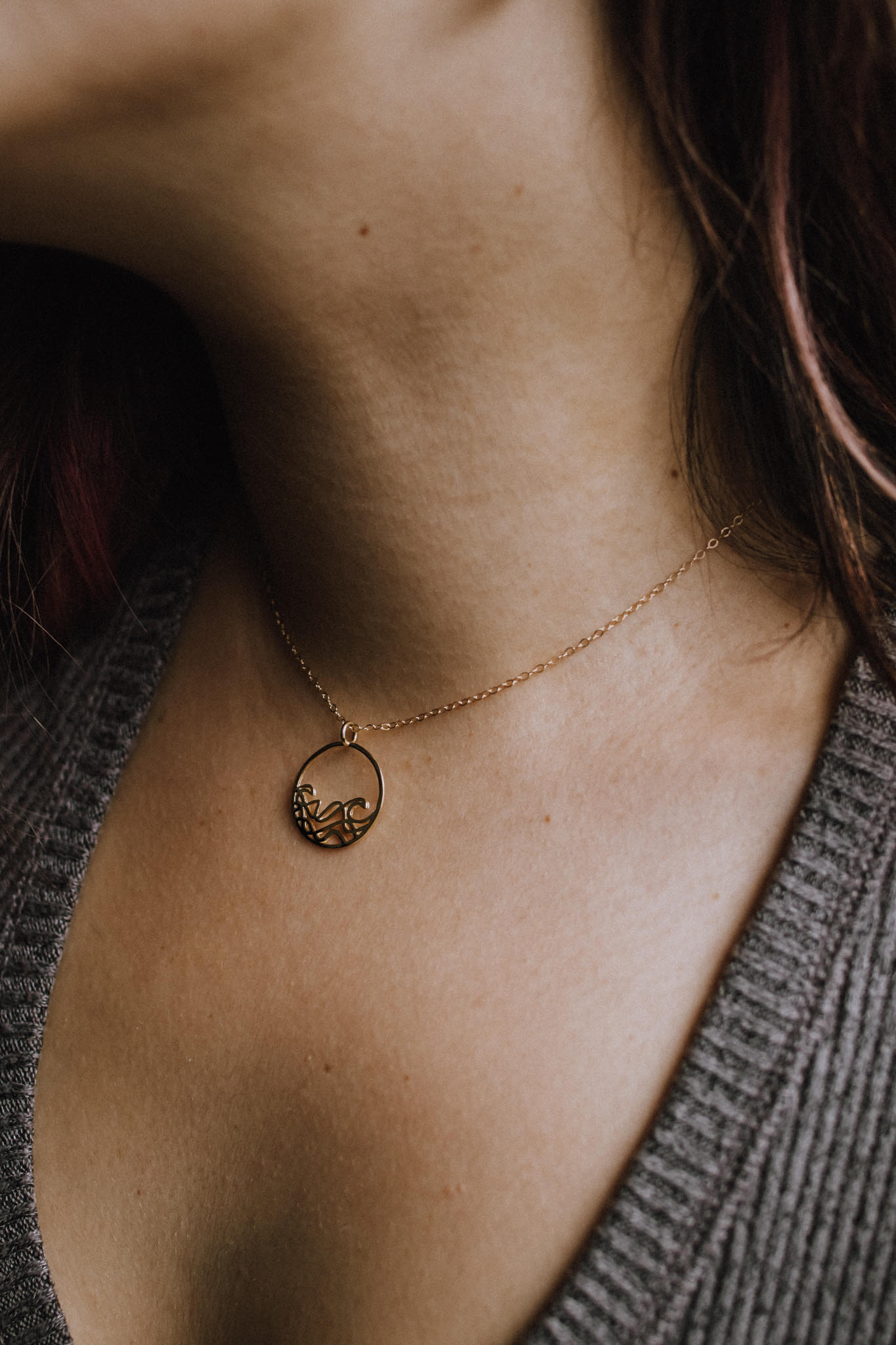 Model wearing 18k rose gold plated Petite Sombrio Ocean Surf Wave Circle Necklace