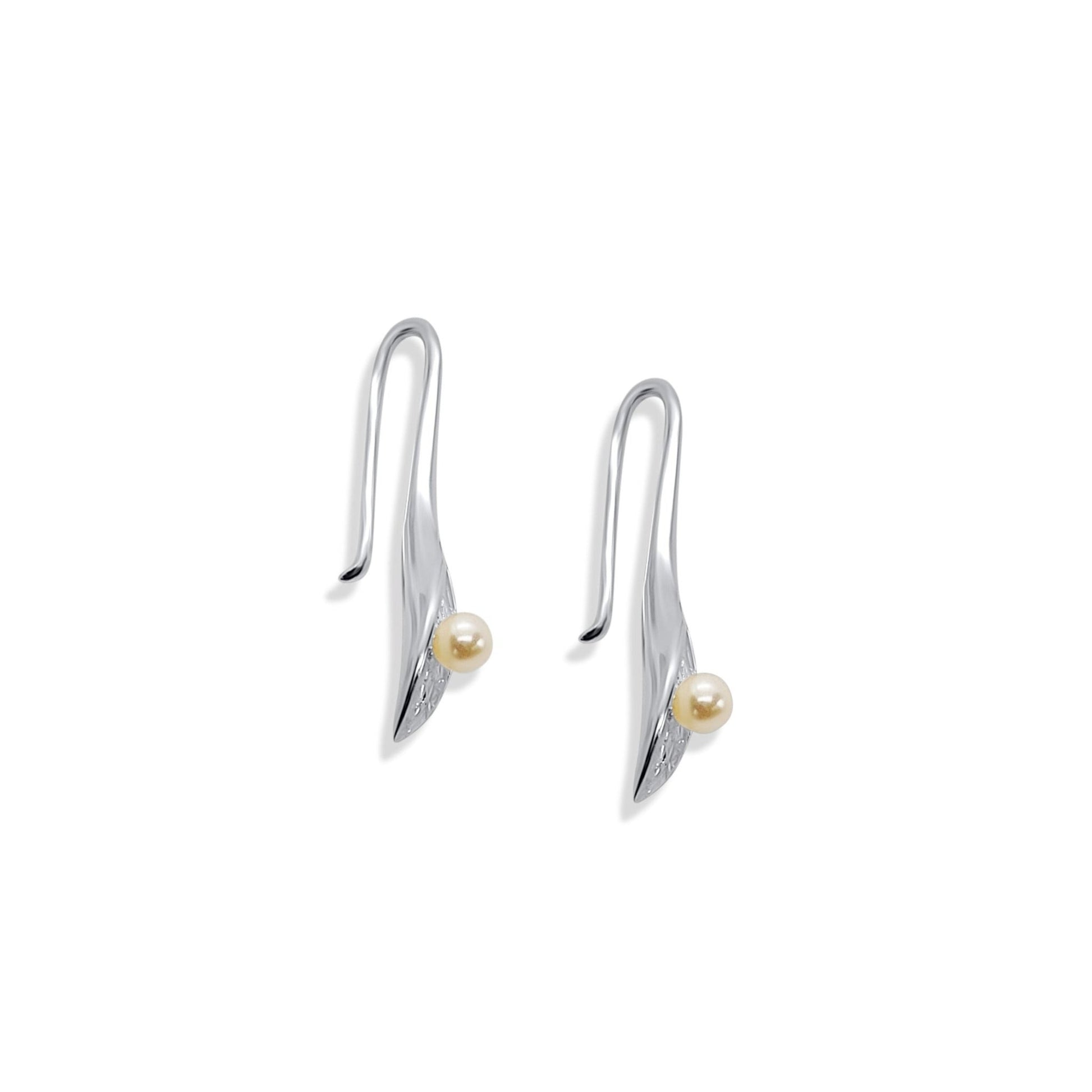 side view of silver cala lily drop earrings with freshwater pearls