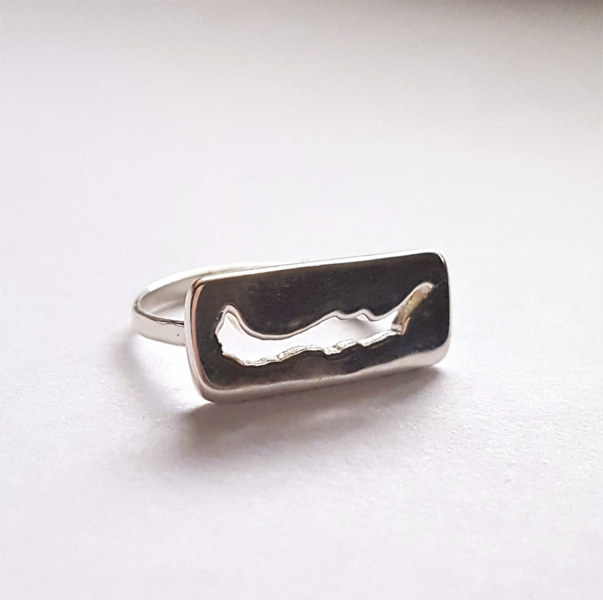 Savary island jewelry. sterling silver ring with rectangle insignia with savary island shape cut out