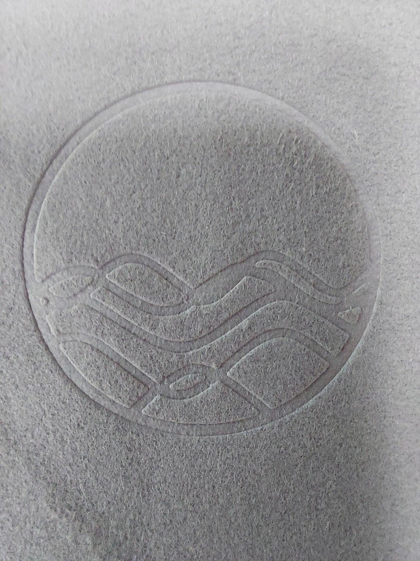 Close up of grey polish cloth for silver with high tide embossed logo