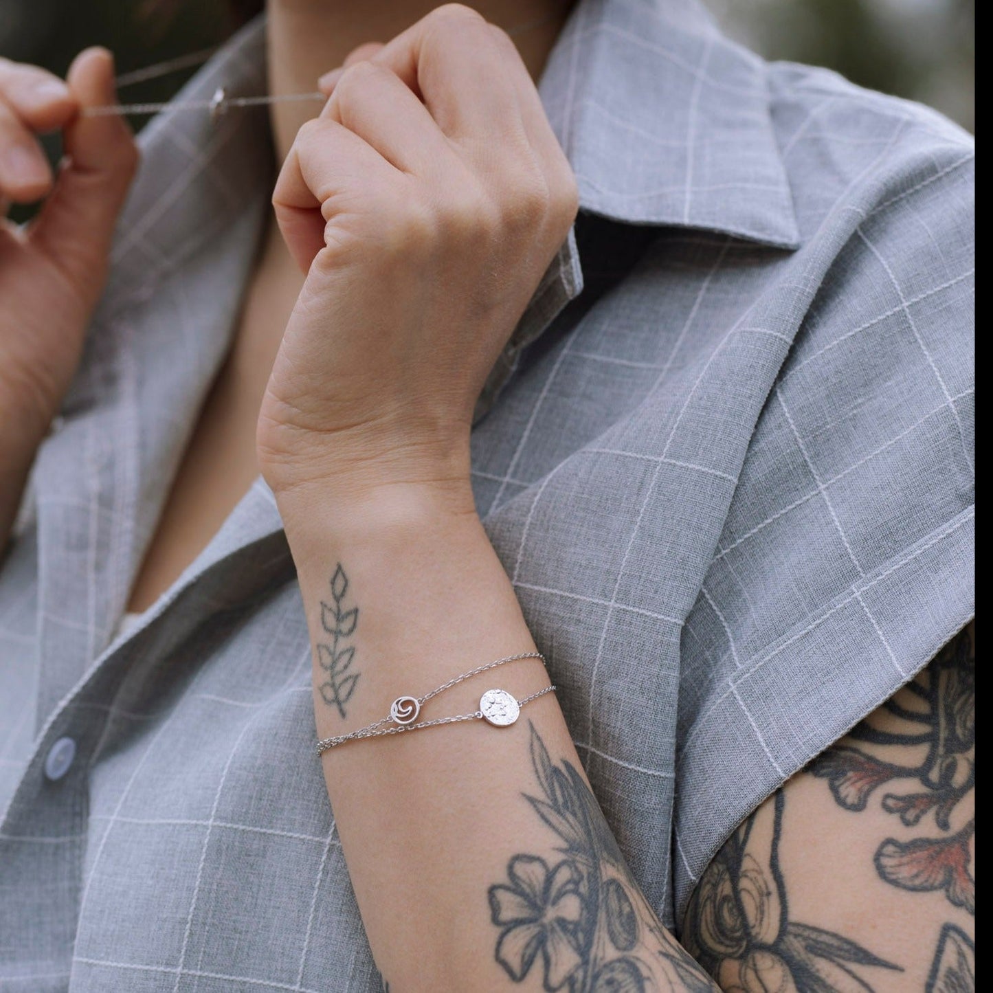 model wearing sterling silver Sol adjustable textured circle charm bracelet closeup