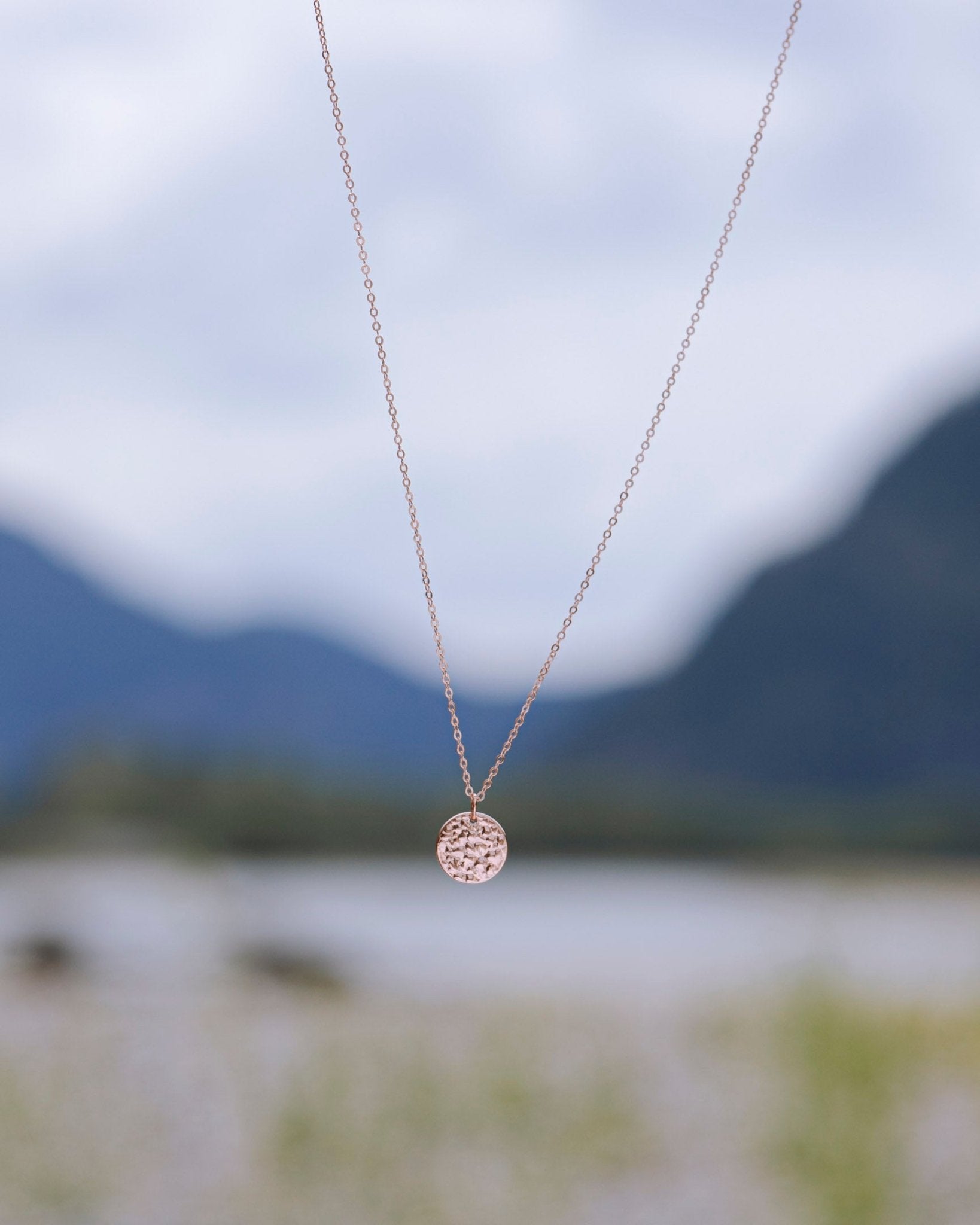 18k rose gold plated Sol Textured Small Circle Pendant Necklace on nature blur background - 1