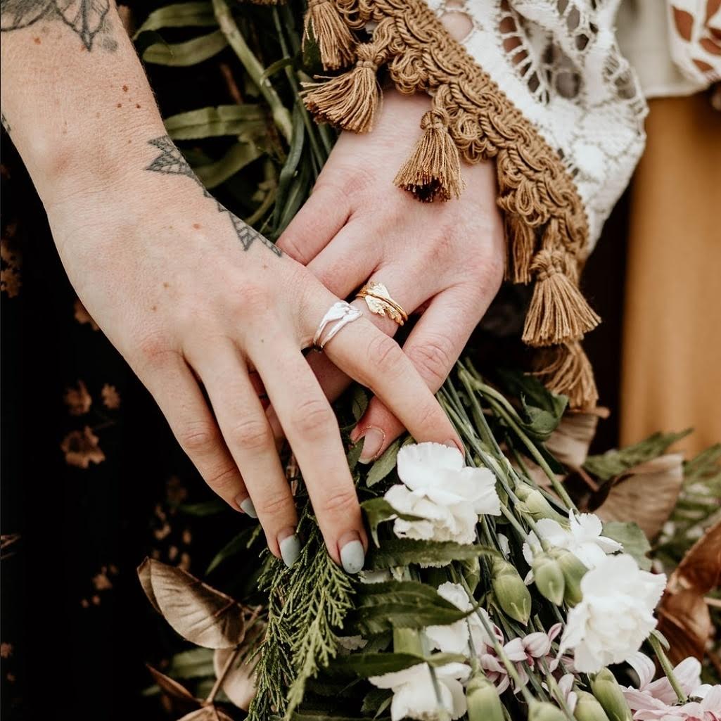 models hands close-up of sterling silver and gold plated silver ring with detailed cedar leaf design