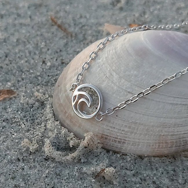 rhodium plated Sterling silver Tofino Surf Wave Adjustable Bracelet on white seashell