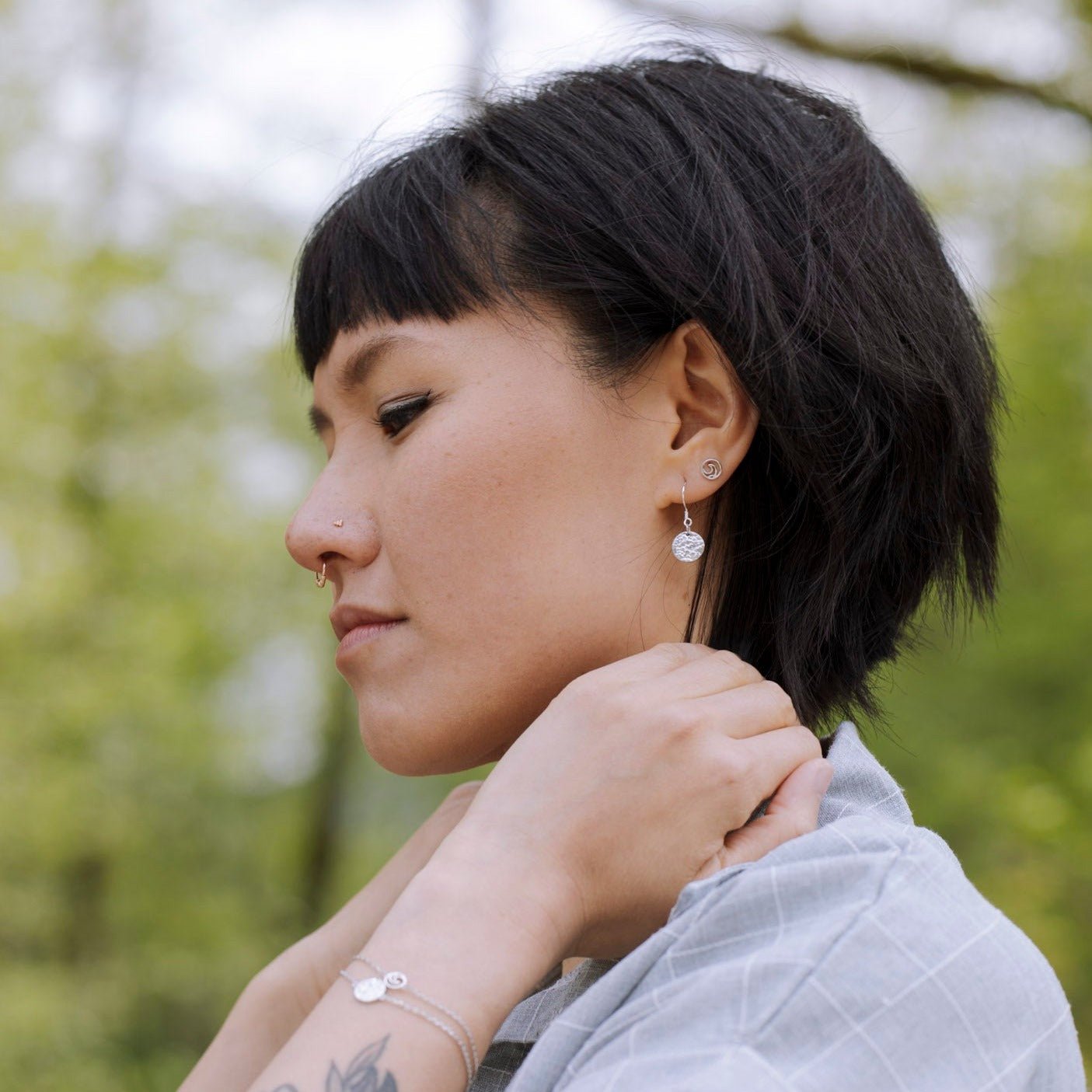 model wearing 925 Sterling Silver Tofino Little Circle Surf Wave Stud Earrings