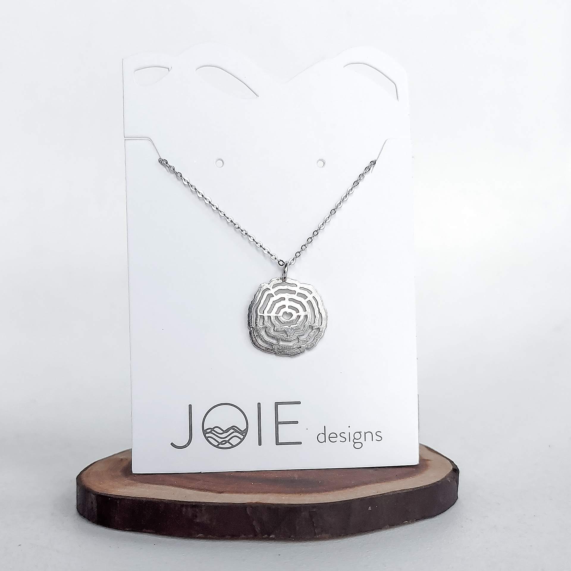 sterling silver Vita Tree ring pendant necklace with heart center cut out on white jewelry card