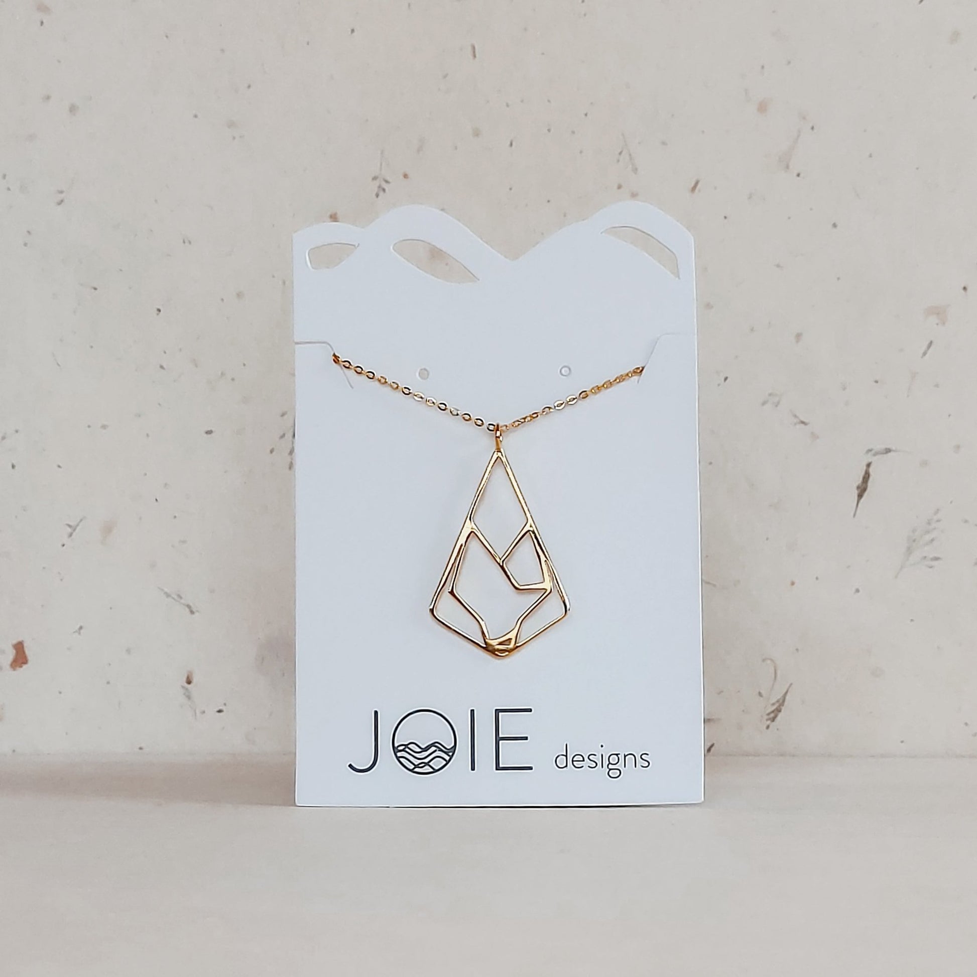 18k yellow gold plated wolf pendant necklace displayed on a white jewellery card