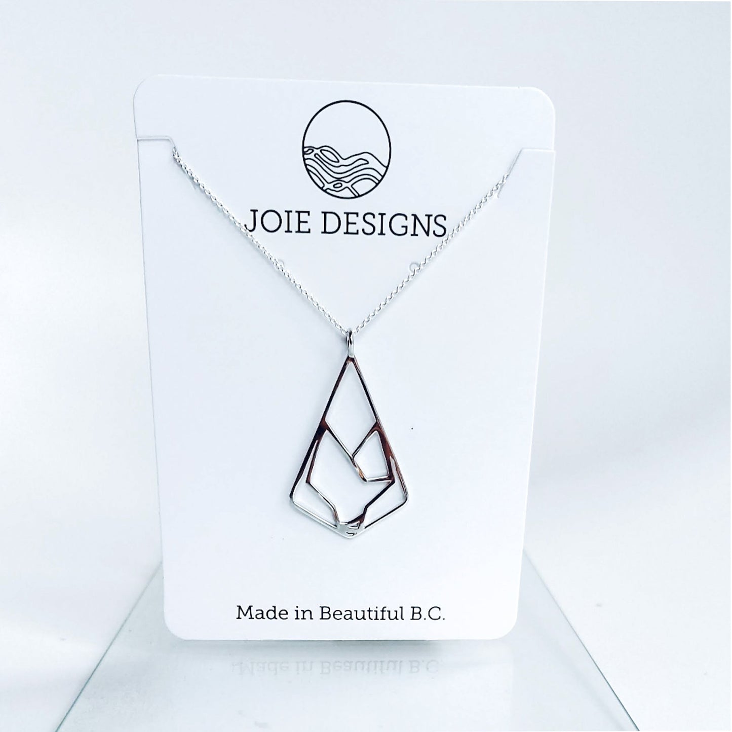 sterling silver wolf pendant necklace displayed on a white jewellery card